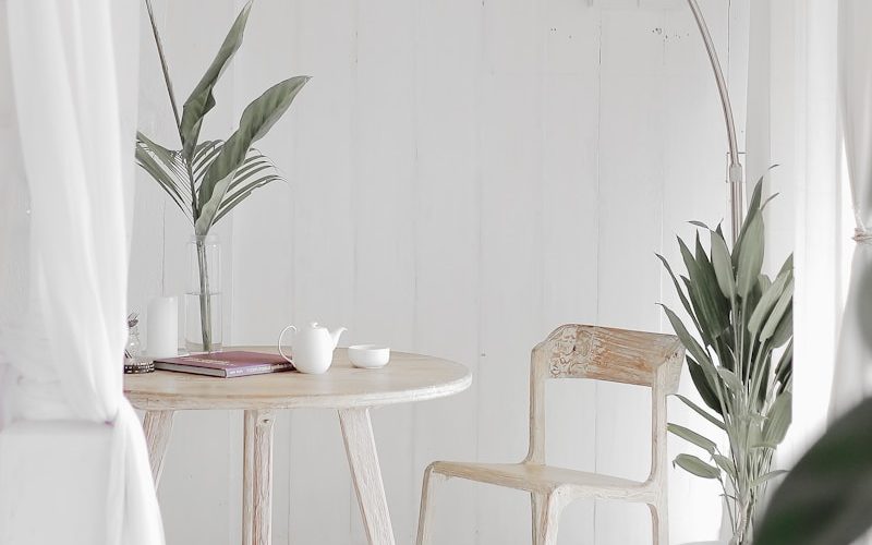 white steel chair in front round table on white rug