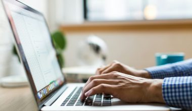 person typing on silver MacBook