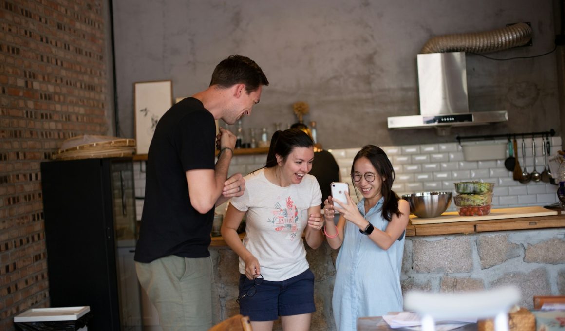 woman wearing white crew-neck shirt looking at smartphone friends